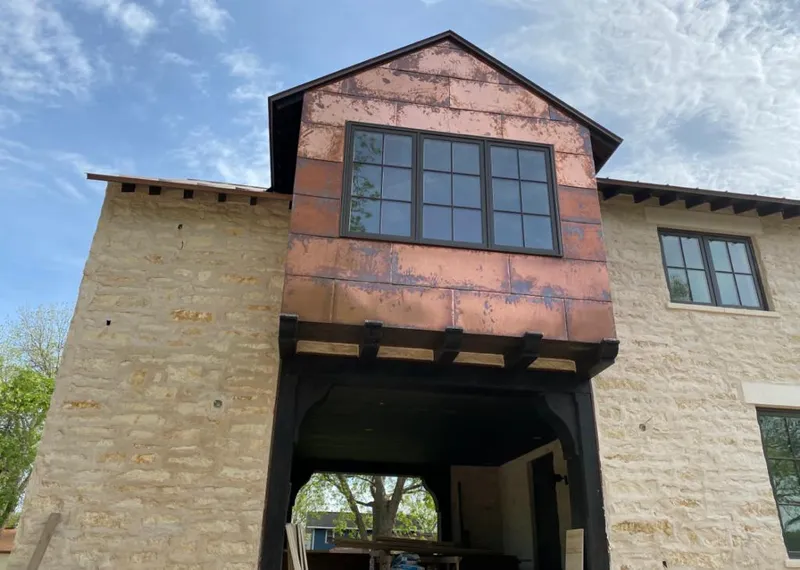 Copper metal panel facade on a stone building for Skylight Installation in Oak Harbor